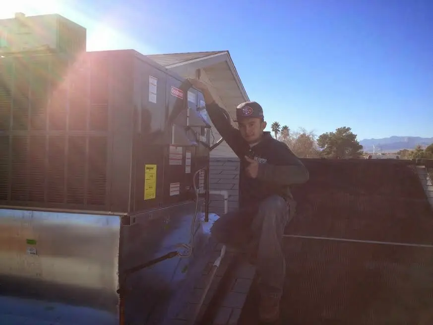 HVAC technician performing Boiler Repair on a rooftop unit in Antis